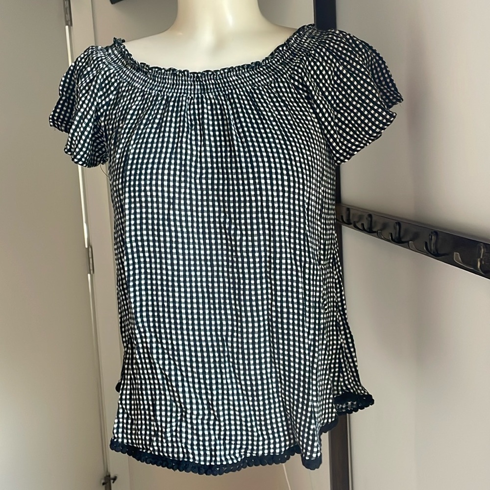 Gingham style on or off the shoulder flowy top with flutter sleeves .